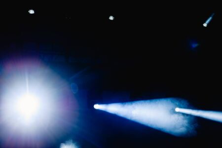 Black background with light bulbs illuminating the darkness with sparkles.の写真素材