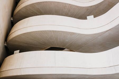 Architectural background with curved lines of warm tones and light and white color.の写真素材