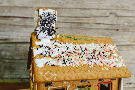 Gingerbread house decorated with colored sugar.