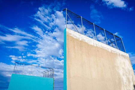 Cement walls of the wall of a pediment for outdoor sport with sky background with clouds.の写真素材