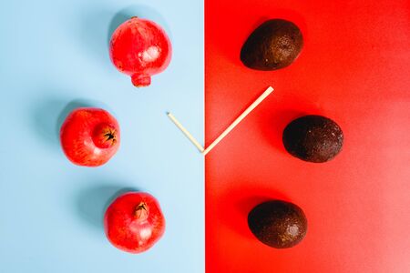Colorful background composition with healthy fruits and clock-shaped sticks