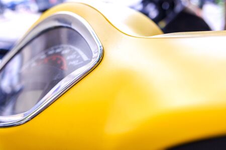 Yellow background of the plastic dashboard of a city scooter.の写真素材