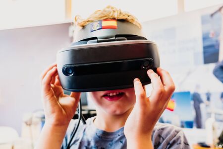 Boy using a VR virtual reality glasses in a demonstration.