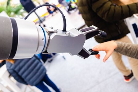A robot arm played with a child in an innovative engineering and industry exhibition.の写真素材
