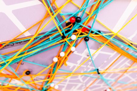Network connections on a city map made with pins and threads.の写真素材