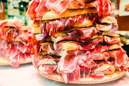 Pile of serrano ham sandwiches, typical Spanish sandwich, for tourists.の写真素材