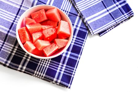 Refreshing pieces of watermelon in a bowl viewed from above, on a white table.の写真素材