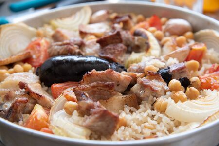 Detail of traditional Spanish dish, Mediterranean food, oven rice with sausage.の写真素材