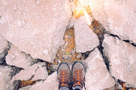 Adventurous man standing on some rocks at sunset, copy space for text.