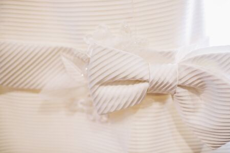 Detail of a white wedding dress hanging.の写真素材