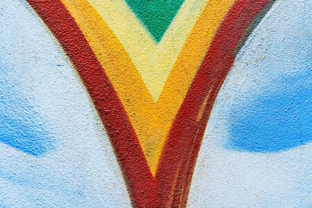 Detail of a drawing on an abandoned wall, with various colors and fun shapes in the background.の写真素材