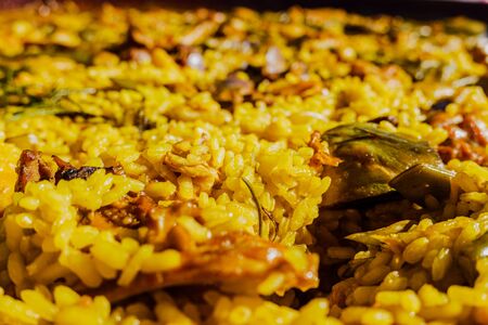 Detail of a yellow paella, Mediterranean rice from the gastronomy of Spain.の写真素材