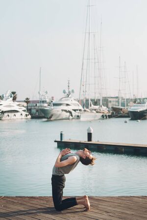 Ustrasana, Camel Pose or back bending pose, to improve back pain thanks to yoga.の写真素材