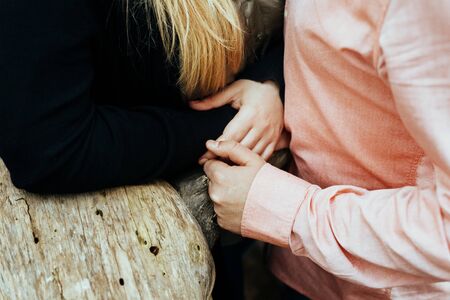 Affectionate husband caresses his beloved's hand.