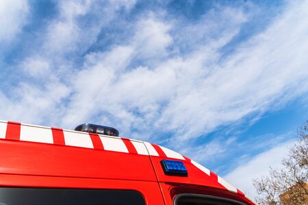 Red ambulance detail during the day with sky in the background, medical concept.の写真素材