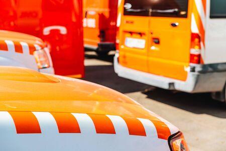 Detail of a fire and emergency vehicle, with the unfocused background of a fire engine parking lot.の写真素材