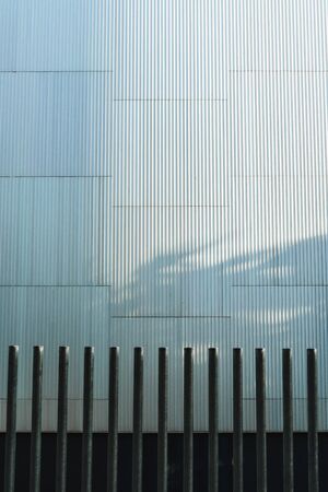 Corrugated aluminum plate building with steel bars, vertical image.の写真素材