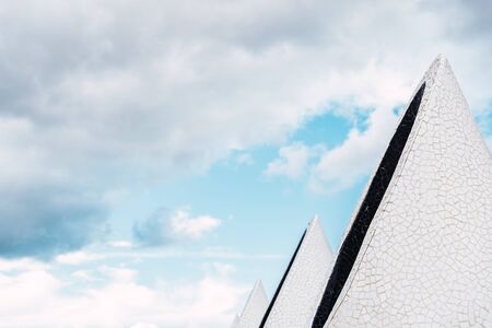 conical buildings in a city with white material, and background of the bluish sky.の写真素材