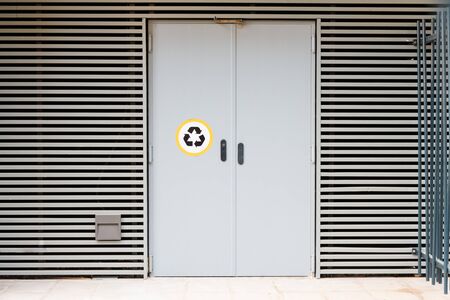 A door of a residential building to deposit recyclable garbage.