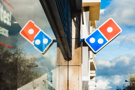 Valencia, Spain - March 5, 2020: Dominos pizza restaurant, with its logo reflected on the glass, in the financial area of Valencia.のeditorial素材