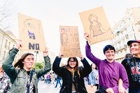 Valencia, Spain - March 8, 2020: Strong slogans about machismo in banners carried by women in a feminist demonstration.のeditorial素材
