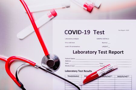 Laboratory report with test tubes with coronavirus-infected blood, causing the global covid-19 pandemic.の写真素材