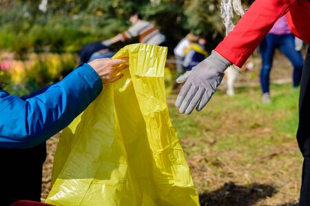 Garbage bags full of plastic bottles abandoned in nature recycled by volunteers.の写真素材