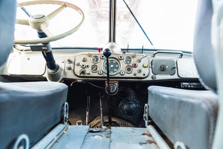 Dashboard and steering wheel of an old retro American van still in use.の写真素材
