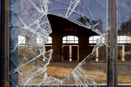 Stoned window with broken glass of an industry.