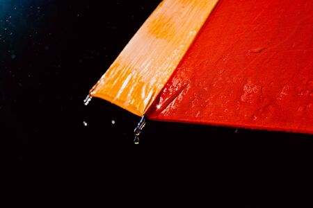 Detail of an umbrella with raindrops after a rainy day.