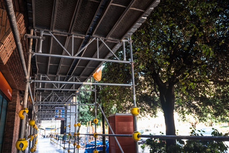 Valencia, Spain - May 22, 2020: Metal scaffolding placed on the street during the repairs of a...