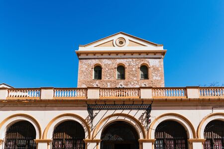 Arched facade of an old school of traditional Spanish architecture.の写真素材