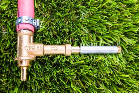 Gas bypass regulator connected to plastic pipes, on grass.の写真素材