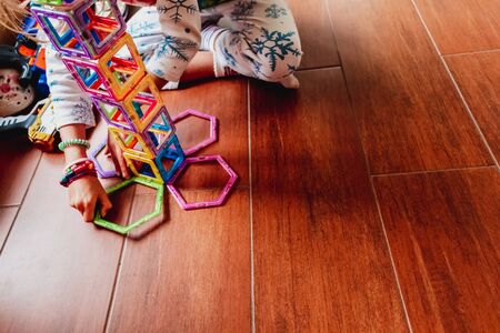 Child playing with building blocks to learn motor and social skills.の写真素材