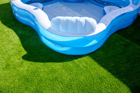 A small fillable plastic, rubber pool in an outdoor garden.の写真素材