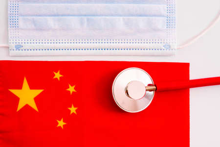 Mask to avoid contagies and Chinese flag isolated on white background.の写真素材