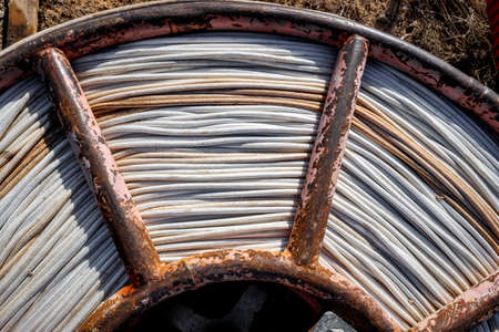 Rusty coil of white rope for construction.の写真素材