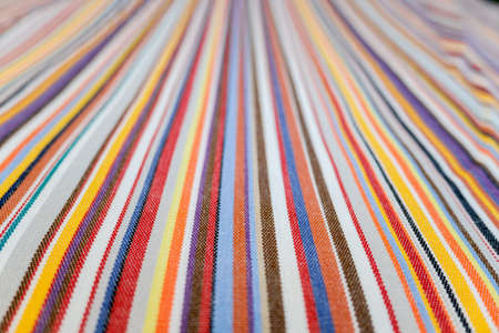 Parallel colored lines on a fabric, blurred background out of focus at the end.の写真素材