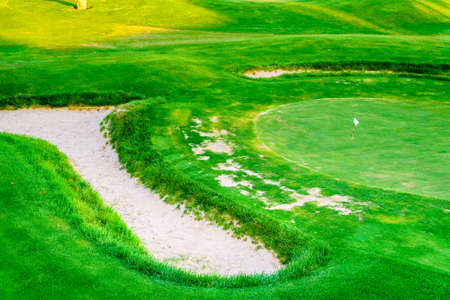An empty golf course green a little run down.の写真素材