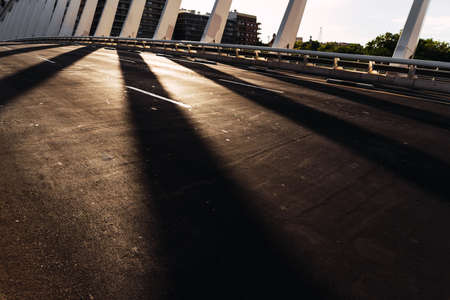 Silhouette of a modern metal bridge in the city at sunset, dark mood.