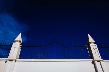 Sign of the cross engraved on the white walls of a cemetery, concept of religious isolation.の写真素材