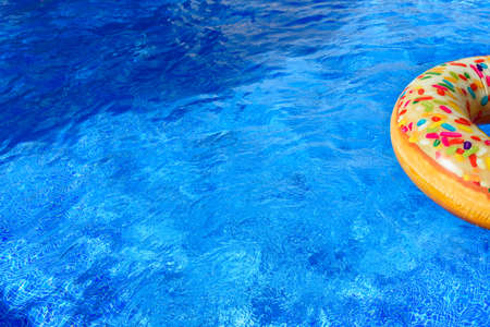 Detail with copy space of a round float in a pool with clean and refreshing waters, background with...