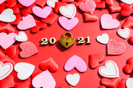 Love padlock on a red background with hearts for Valentine's Day in 2021.の写真素材