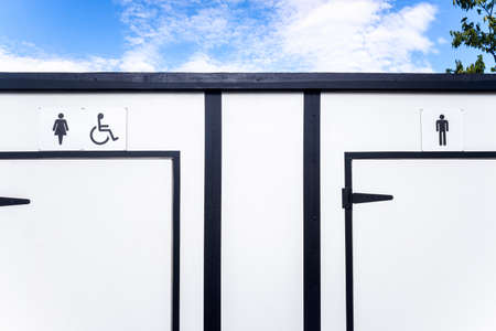 White portable toilets with space for women, men and disabled people.の写真素材