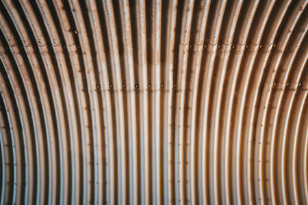 Inside of a large tube with symmetrical folds, made of metallic material.