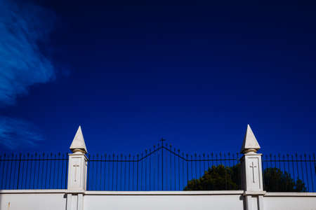 Sign of the cross engraved on the white walls of a cemetery, concept of religious isolation.の写真素材