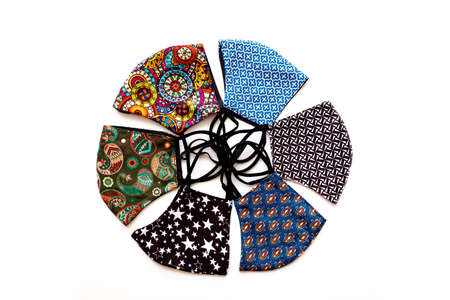 Handcrafted cloth masks with colorful designs against viruses, isolated on white background.の写真素材