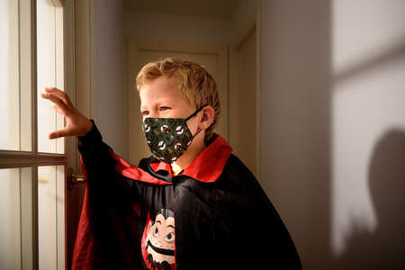 Child with mask dressed as a vampire on halloween.の写真素材