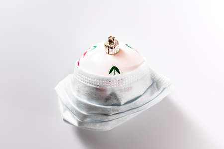 Christmas decoration isolated on white background with masks to avoid virus infections.