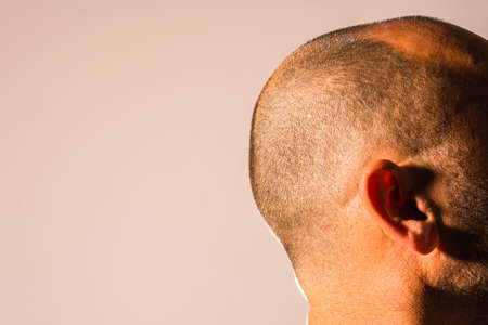 Bald man face portrait with freshly cut hair, isolated on background.